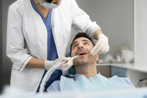 Dentist performing a check-up on a patient as part of the dental implants procedure step by step