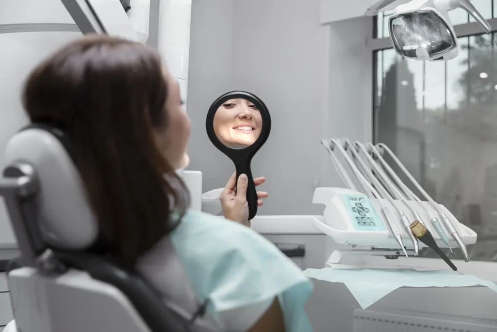 patient smiling and checking teeth in mirror after dental check-ups for dental health