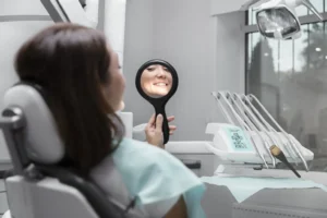 patient smiling and checking teeth in mirror after dental check-ups for dental health