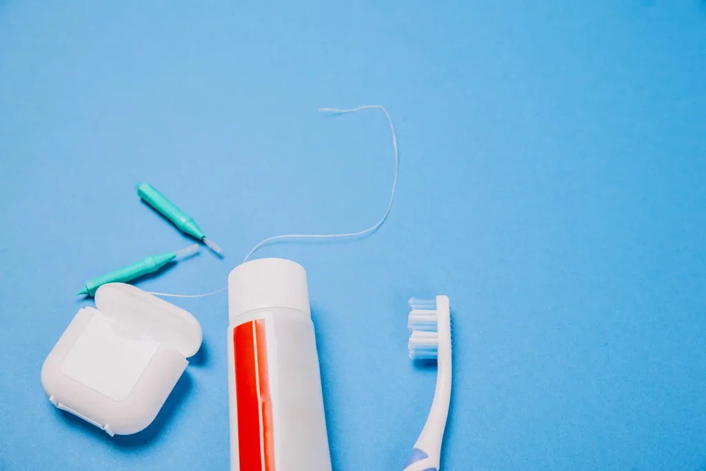 Dental hygiene tools on a blue background, essential for maintaining oral health and preventing gum disease.